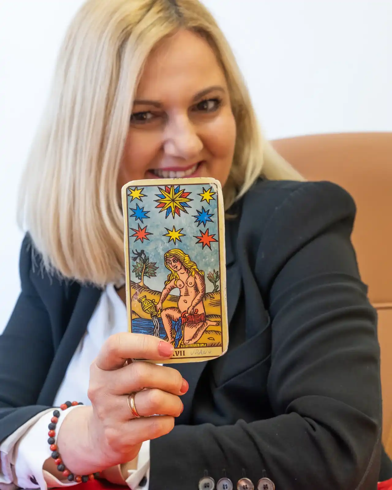 Estela, tarotista del gabinete Tarot Profesora Rossana, muestra a cámara la carta de La Estrella en la consulta de tarot online